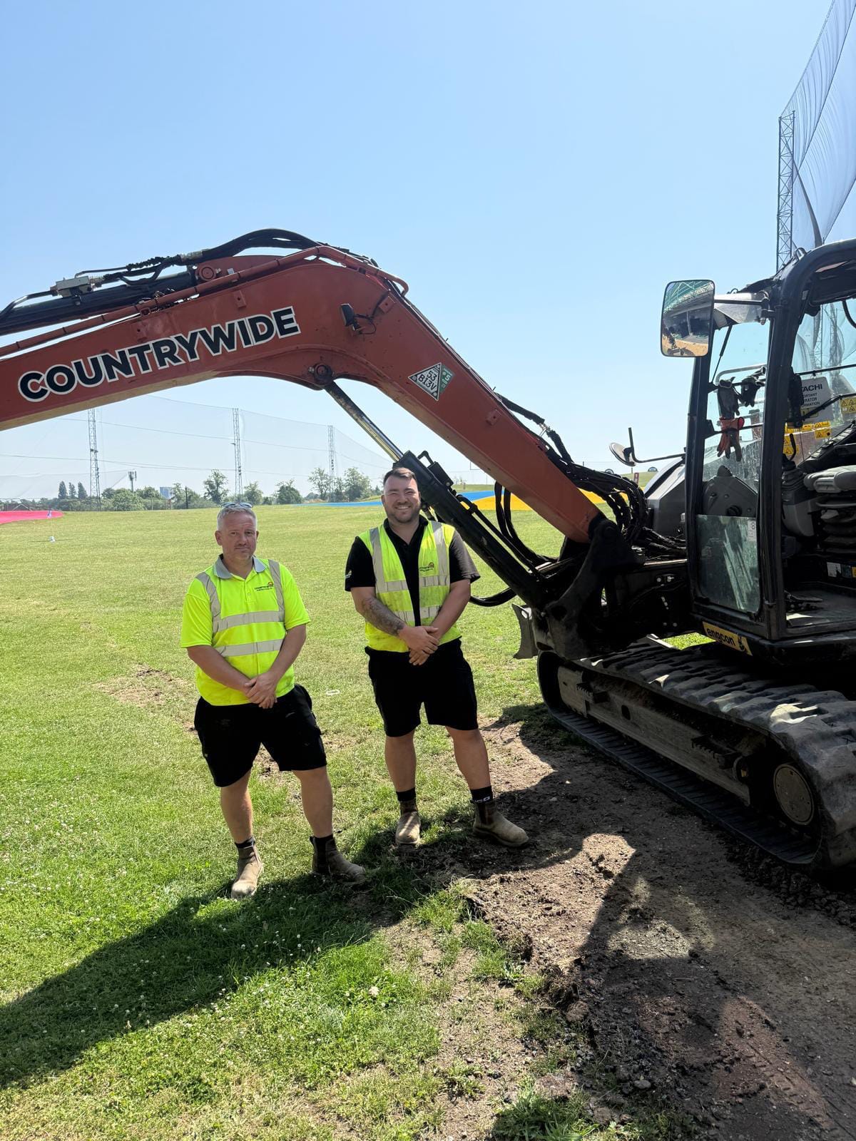 Countrywide Golf team on site with a branded excavator